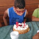 CasaOz - bambino che soffia felice sulla torta di compleanno