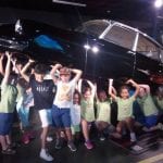 CasaOz - bambini che sorridono in visita al Museo dell'Automobile